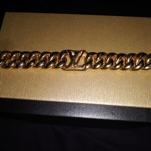 Louis Vuitton Gold Curb Link Bracelet with LV Emblem.